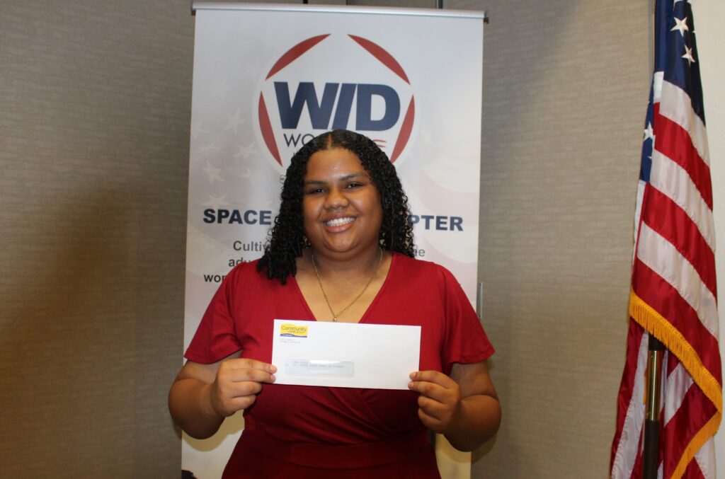 Girl holding an award.