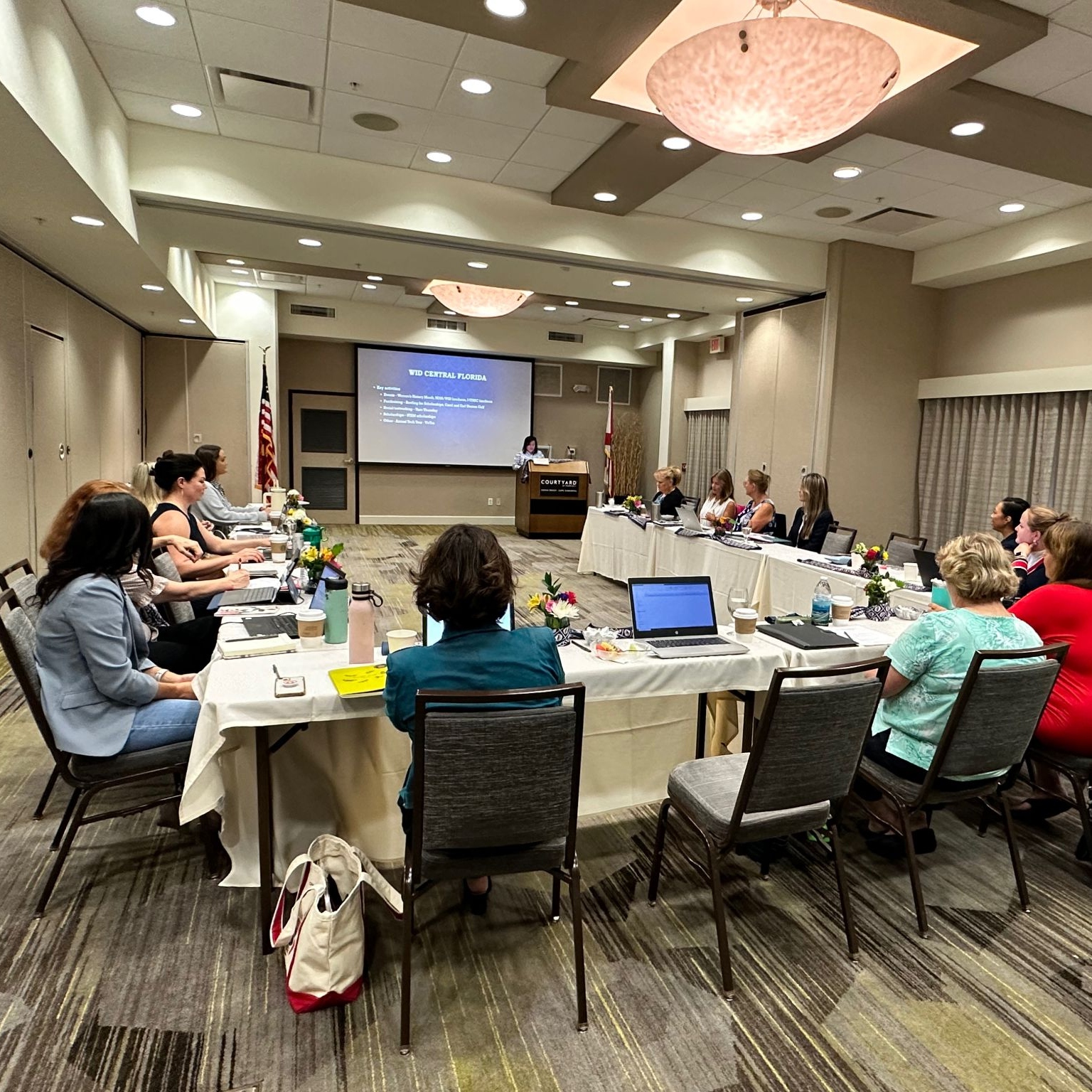 Several WID Space Coast members listen to a speaker
