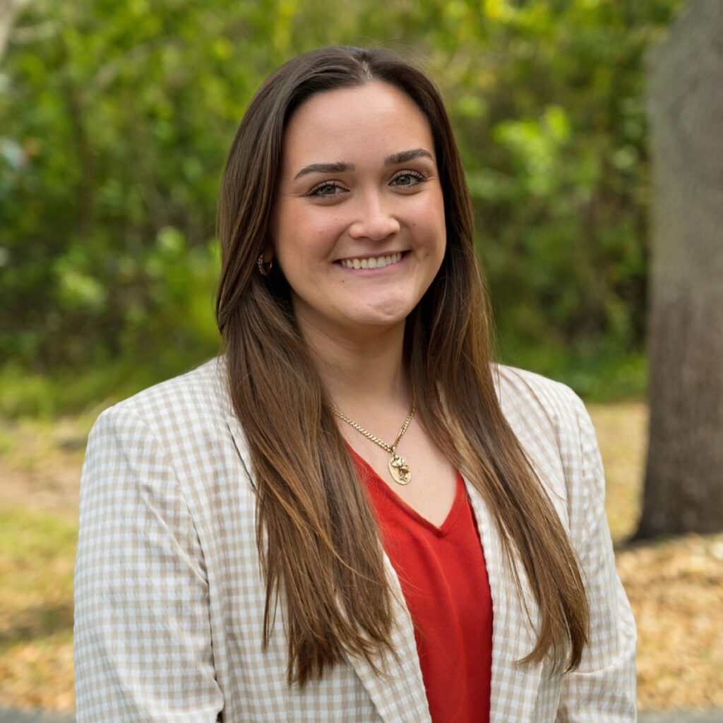 Sirena Ozzello, a past president of WID Space Coast, smies