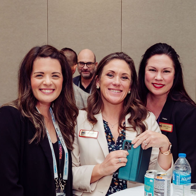 Members of WID Space Coast smile at an event.